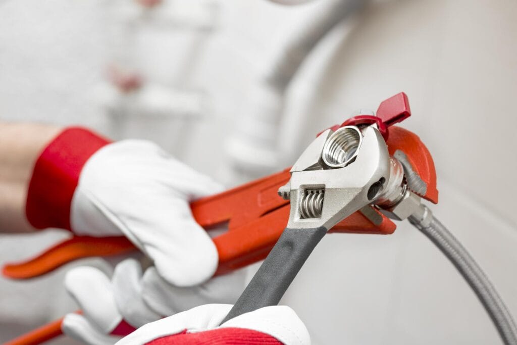 Plumber holding pipe wrenches for an emergency repair in Soledad